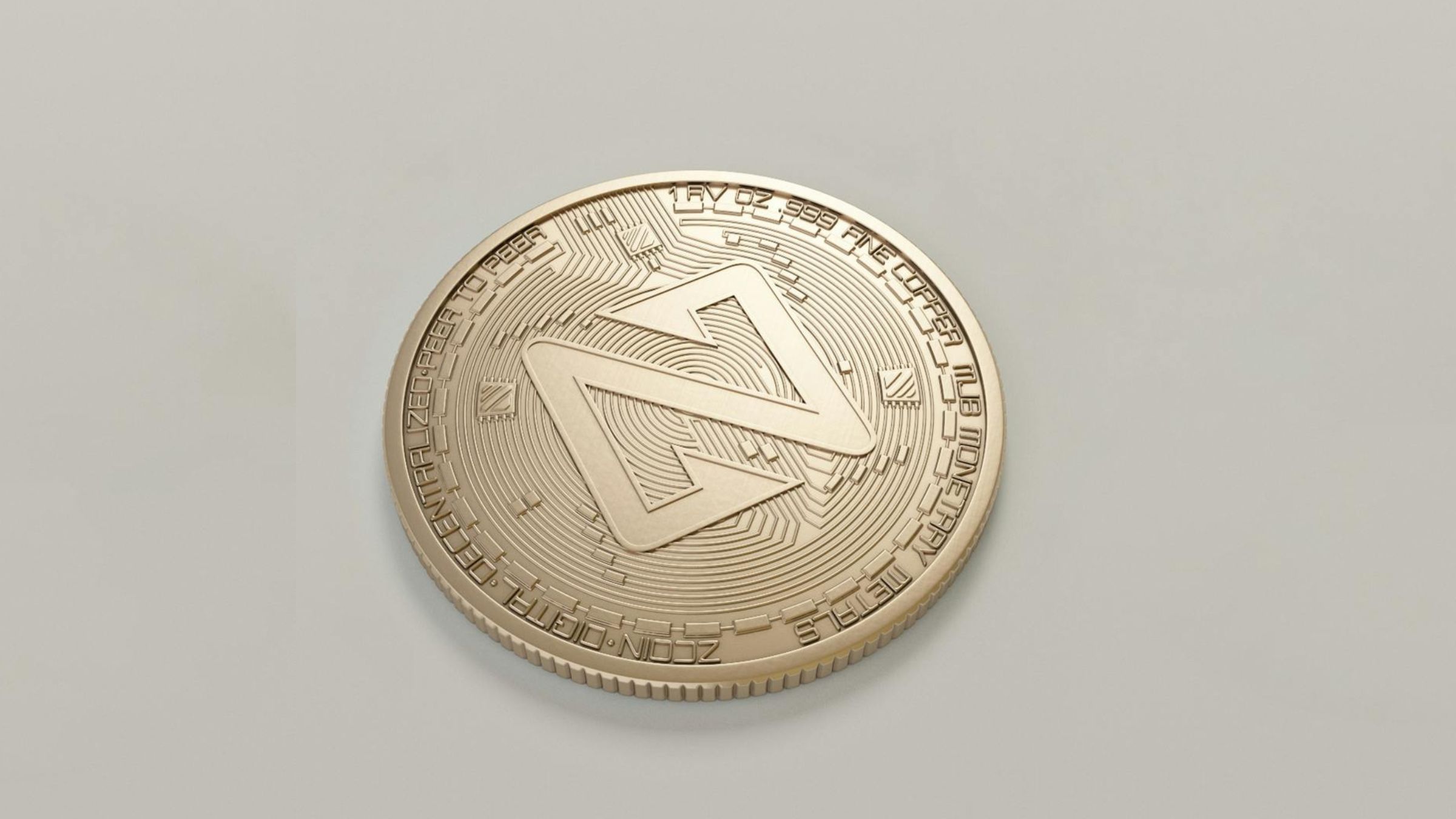 Gold-colored crypto token with an angular emblem and circuit-style detailing on a plain light background.