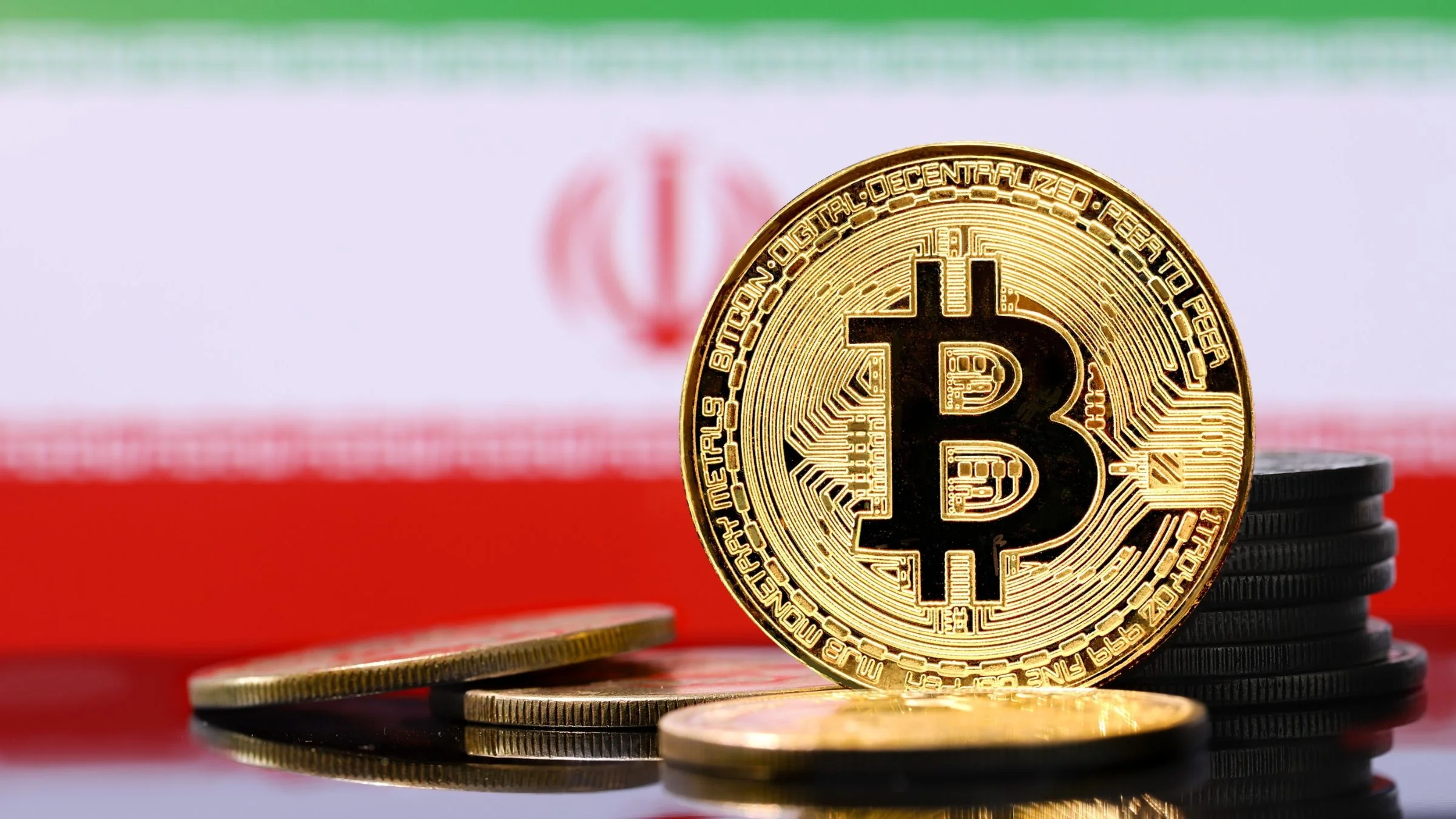 Gold Bitcoin coin displayed in front of the Iranian flag with stacked cryptocurrency tokens