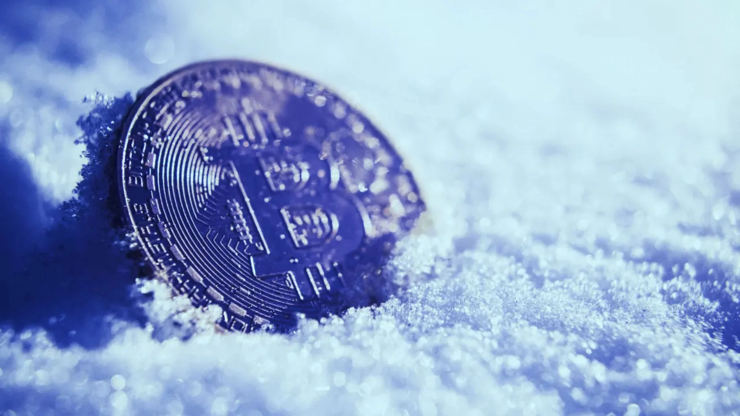 image of bitcoin coin on fresh snow