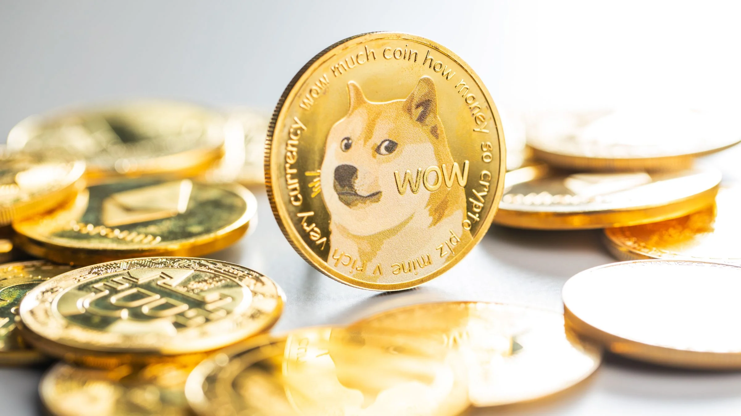 Close-up of a Dogecoin cryptocurrency coin standing among gold crypto tokens
