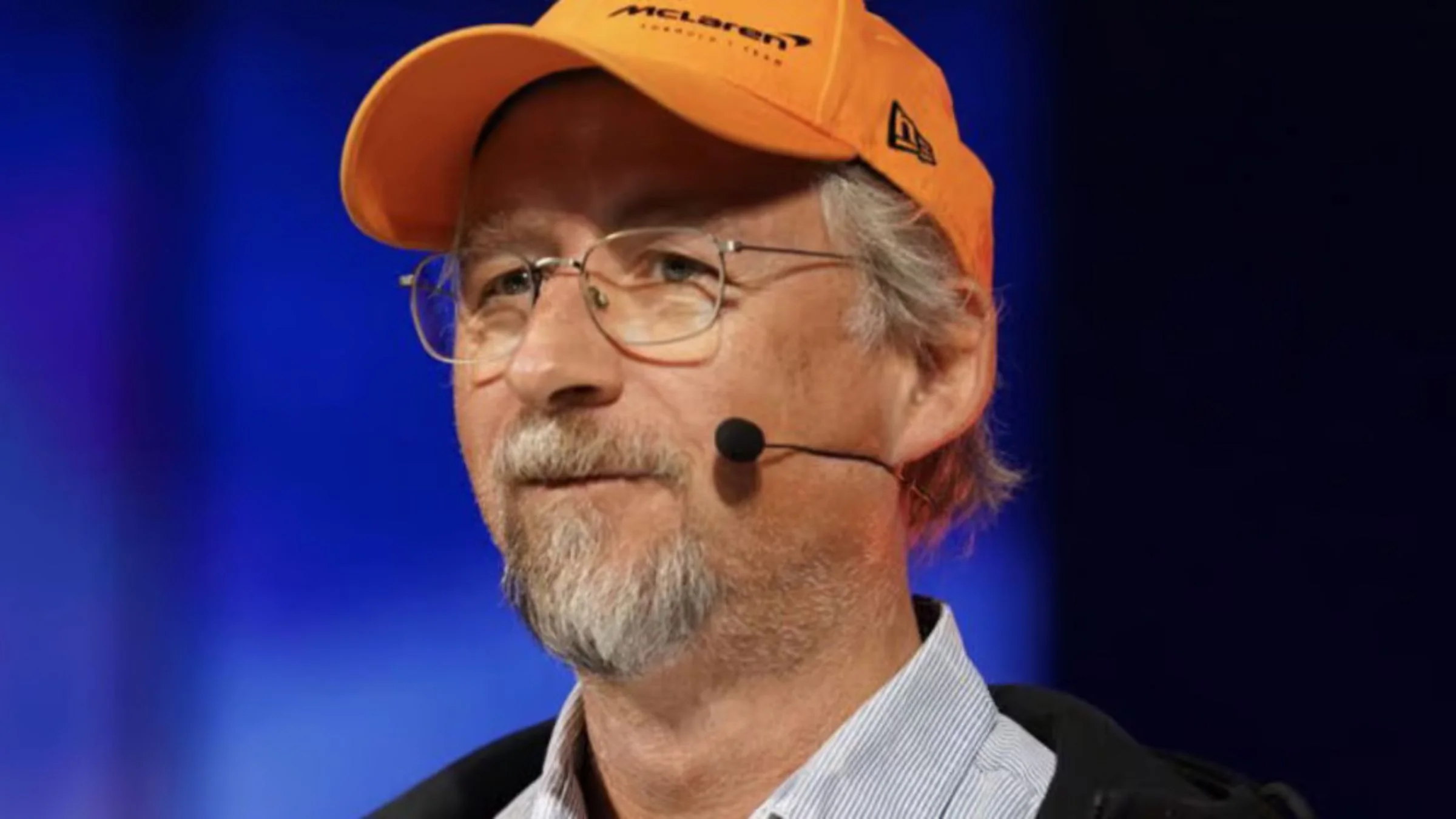 Adam Back wearing an orange McLaren Formula 1 Team cap at a speaking event