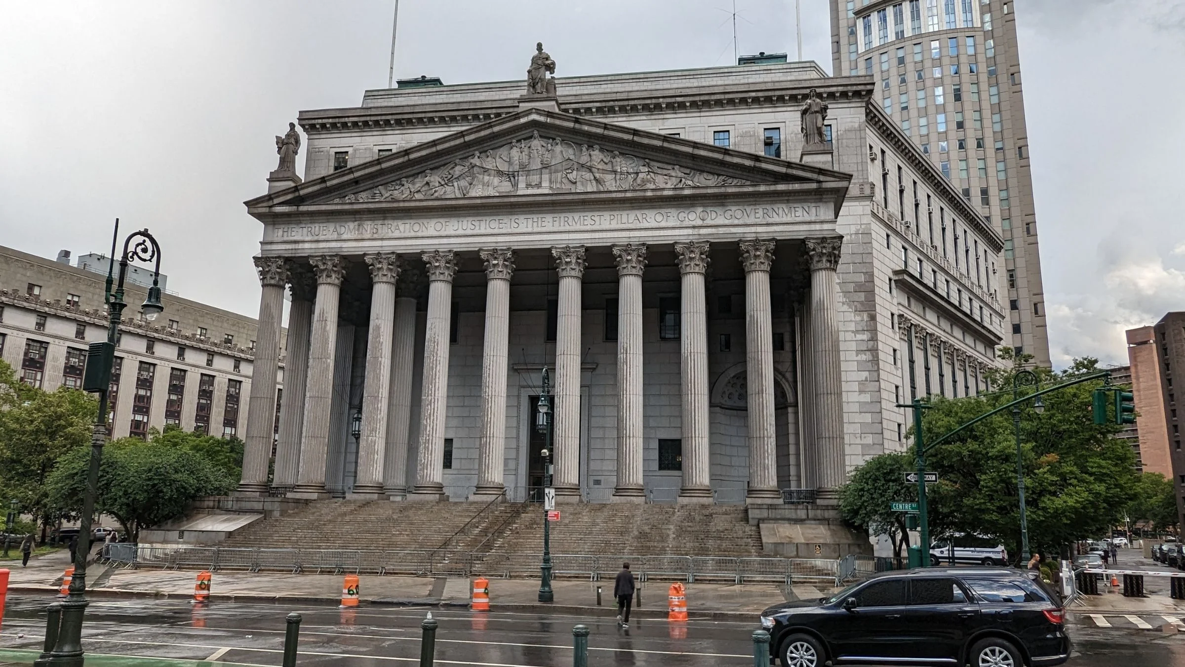 Historic courthouse building with large columns in New York City on a rainy day