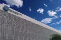 Exterior of the Bank of Thailand headquarters under a blue sky