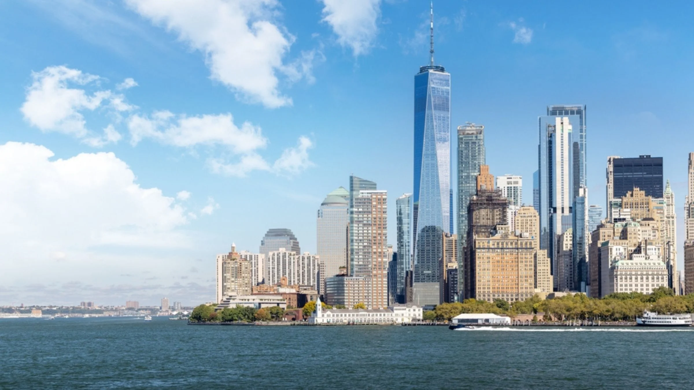The Lower Manhattan skyline viewed from the water, with One World Trade Center prominently visible