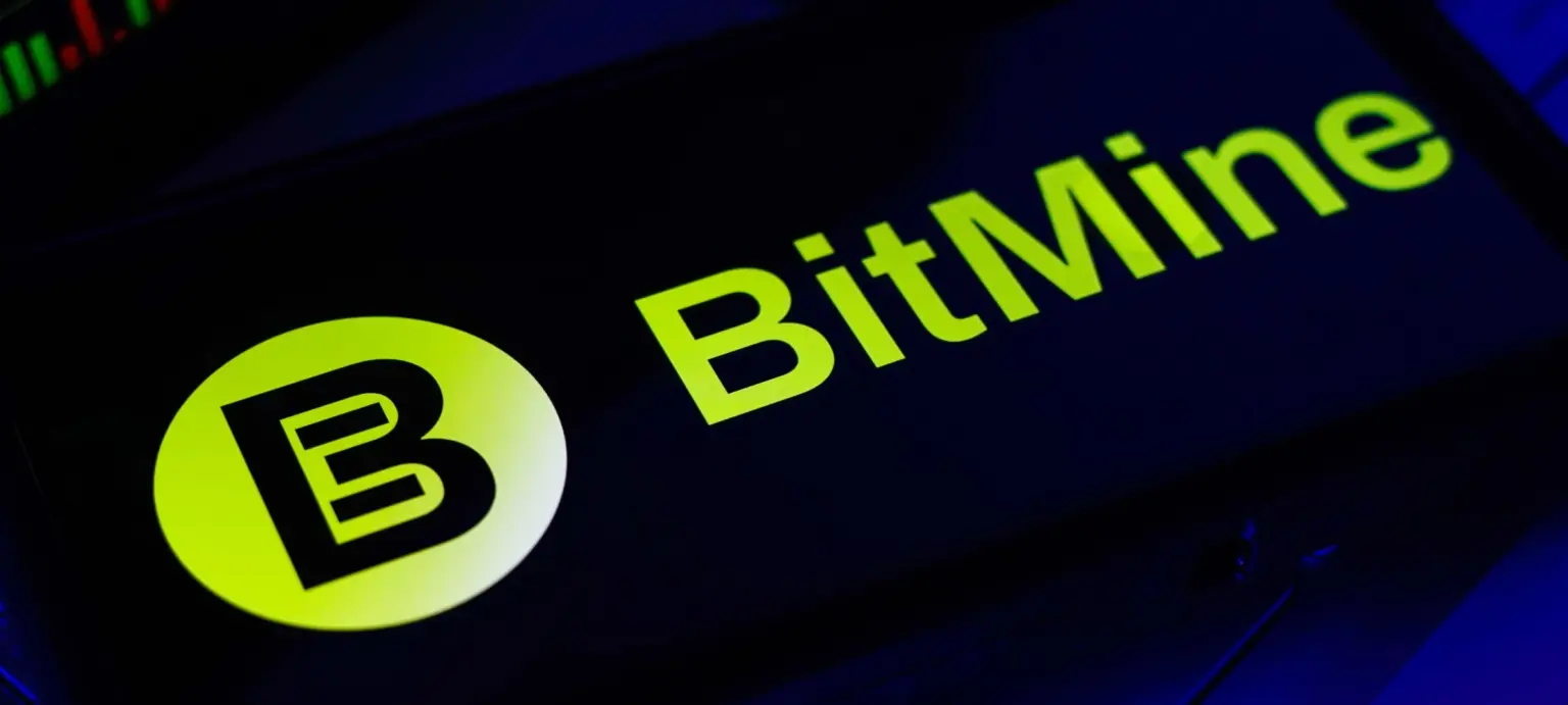 BitMine logo in bright green displayed on a smartphone screen with a blue-lit background