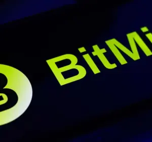 BitMine logo in bright green displayed on a smartphone screen with a blue-lit background