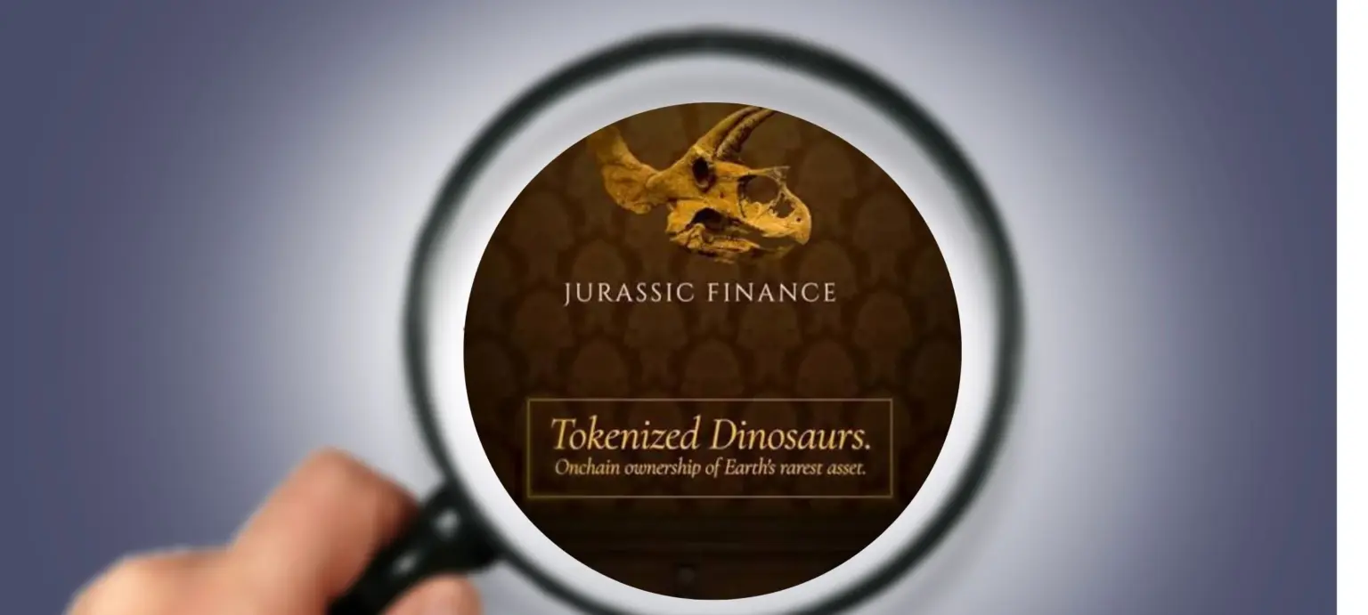 Magnifying glass held over a phone screen showing the Jurassic Finance logo and "Tokenized Dinosaurs" branding