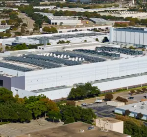 Aerial view of a large data center complex with extensive rooftop cooling and electrical infrastructure.