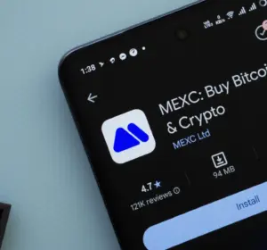 Smartphone screen displaying the MEXC app listing with install button on a light background.