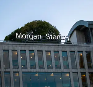 Morgan Stanley office building exterior with illuminated company signage above rows of windows.