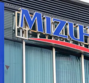 Large Mizuho bank sign mounted on the exterior of a modern commercial building.