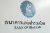 Bank of Thailand emblem and bilingual name displayed on a white interior wall